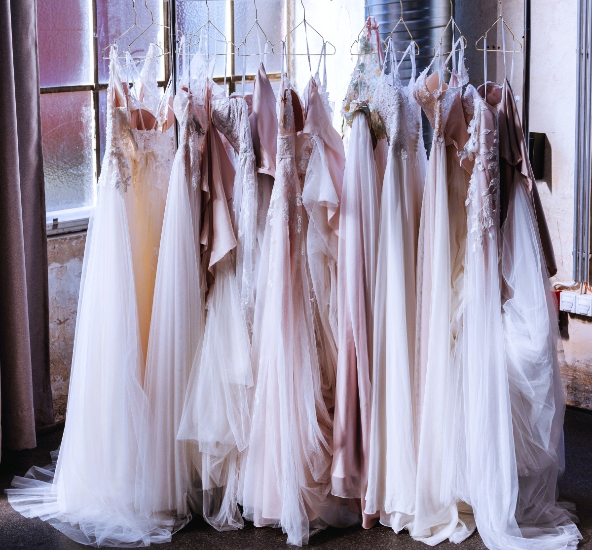 Several bridal dresses on a rack