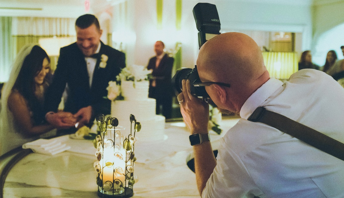 Photographer taking a picture of the bride and groom