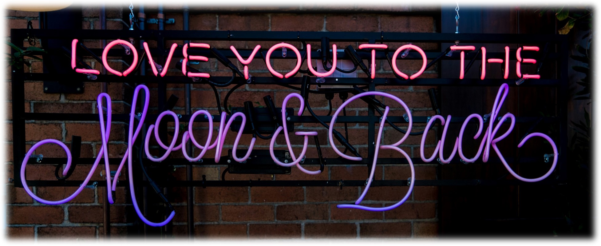 Neon sign that reads 'Love you to the moon and back'