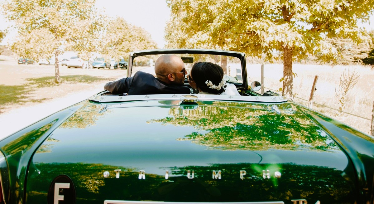 Bridal couple walks to car